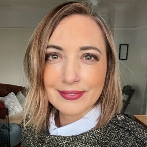 A headshot of Mel smiling at the camera