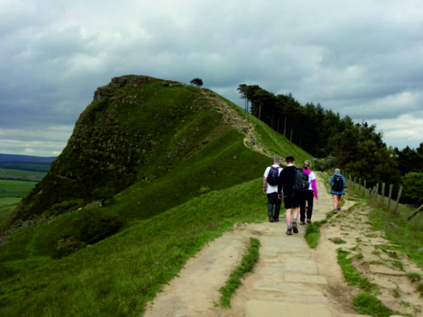 An image of four YHEc staff members approaching a hill on the Knaresborough circular walk
