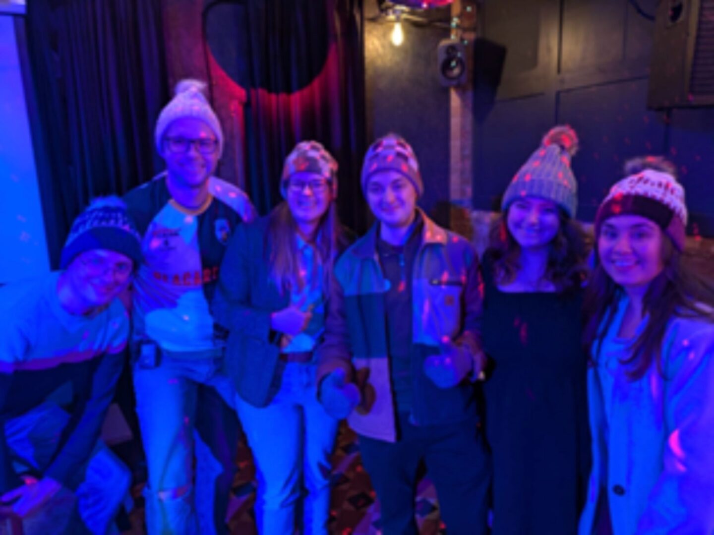 An image of 5 YHEc staff wearing homemade crochet/knitted hats that they won in our quiz/raffle night